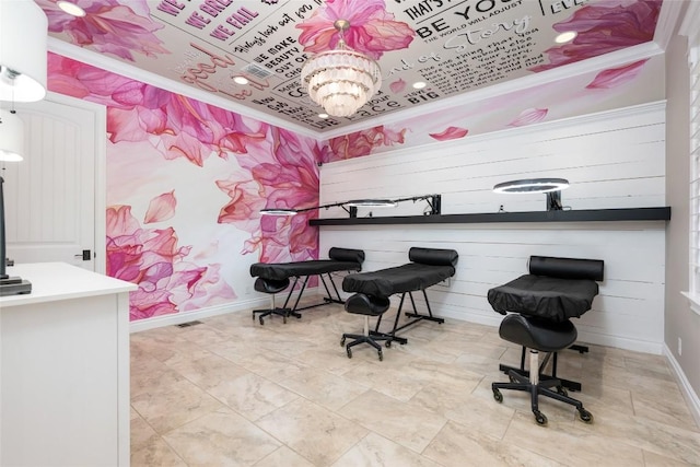 office space featuring crown molding and a chandelier