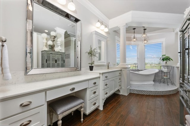 bathroom with vanity, wood-type flooring, a bath, and ornamental molding