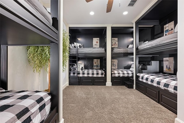 carpeted bedroom with ceiling fan and ornamental molding