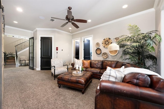 carpeted living room with ceiling fan and crown molding