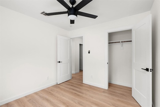 unfurnished bedroom featuring ceiling fan, a closet, and light hardwood / wood-style floors