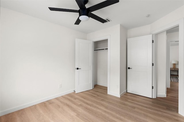 unfurnished bedroom with light wood-type flooring, a closet, and ceiling fan