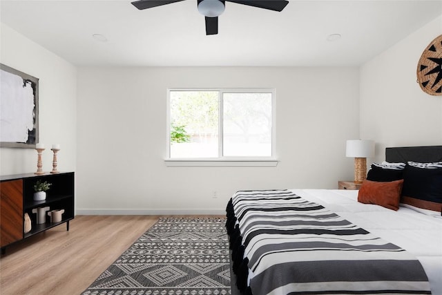 bedroom with light wood-type flooring and ceiling fan