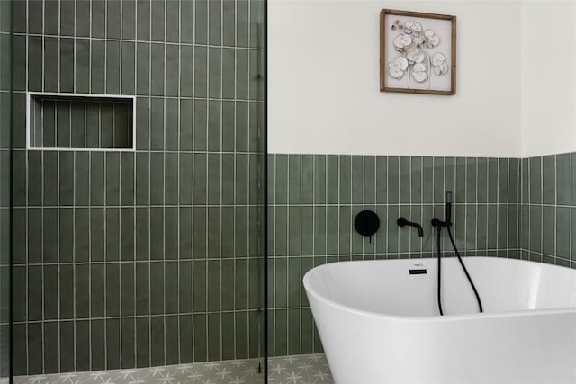 bathroom with a tub and tile patterned flooring