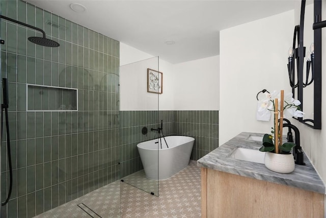 bathroom with separate shower and tub, tile patterned flooring, vanity, and tile walls