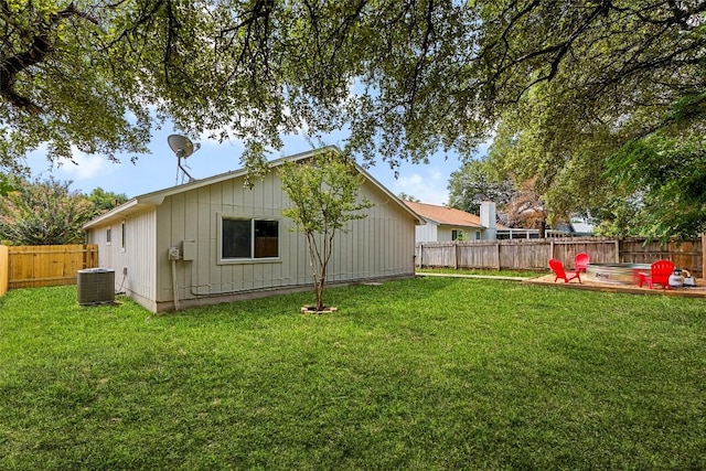 view of yard with central AC unit and a patio area