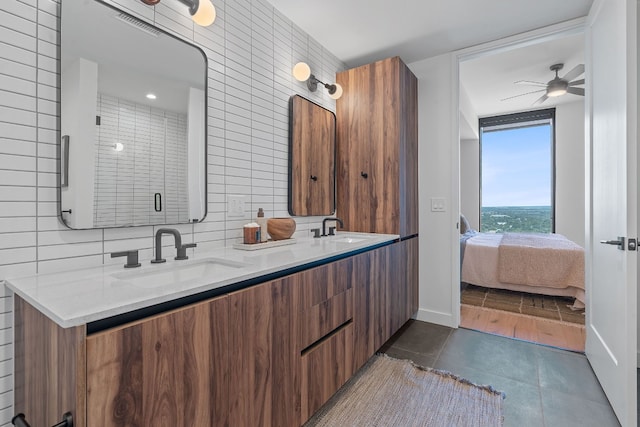 bathroom with ceiling fan, walk in shower, tile patterned flooring, backsplash, and vanity