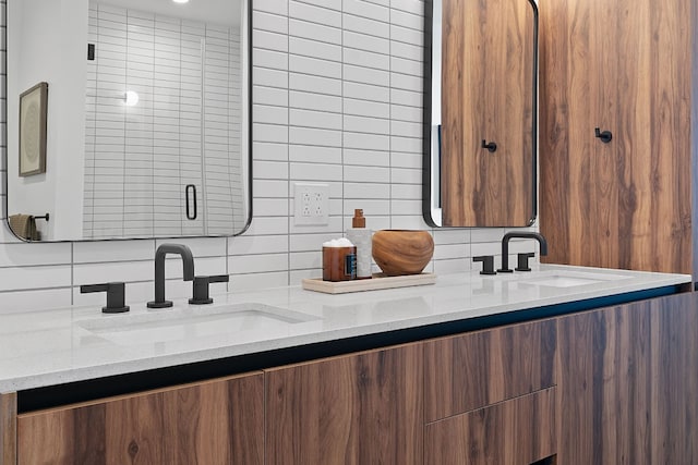 bathroom featuring vanity and backsplash