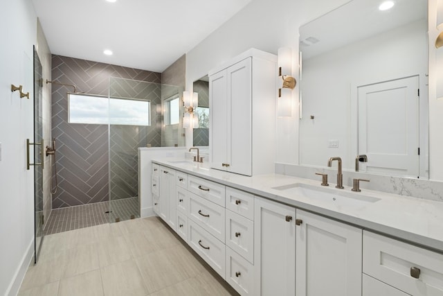 bathroom with vanity and a shower with door