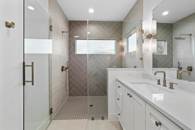 bathroom with walk in shower and vanity