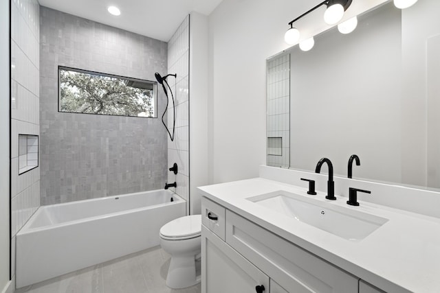 full bathroom with tile patterned floors, tiled shower / bath combo, vanity, and toilet