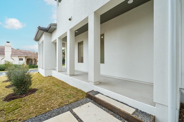 view of home's exterior featuring a patio area and a lawn