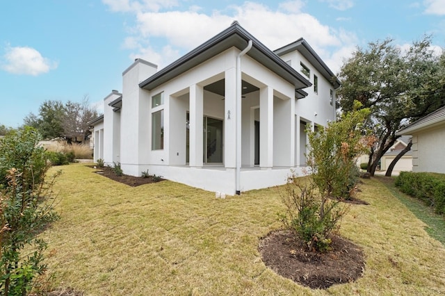 view of side of home with a lawn