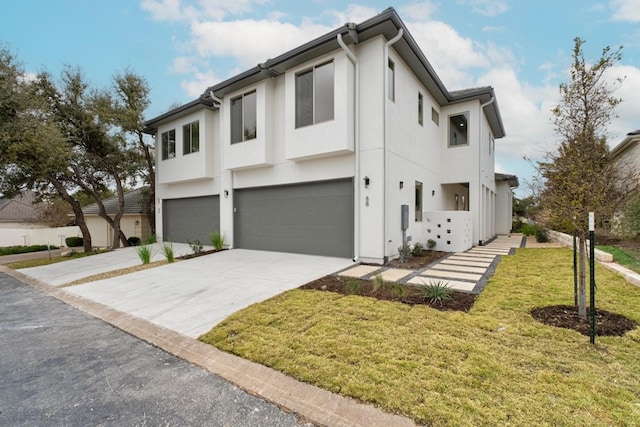 view of front of home with a front lawn and a garage