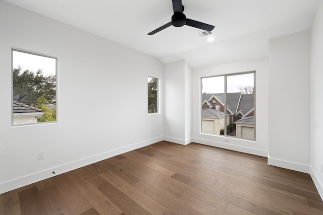 empty room with hardwood / wood-style flooring, a wealth of natural light, and ceiling fan