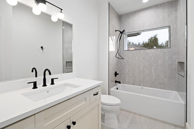 full bathroom with tiled shower / bath combo, vanity, and toilet