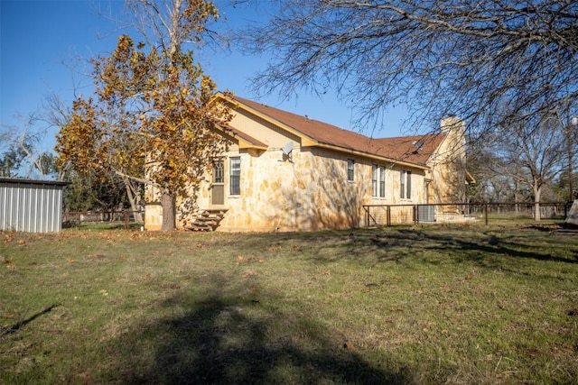 back of house featuring a yard