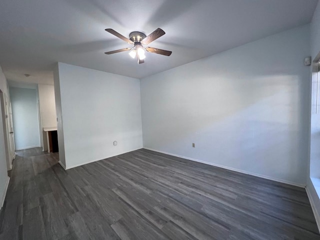 unfurnished room with ceiling fan and dark wood-type flooring