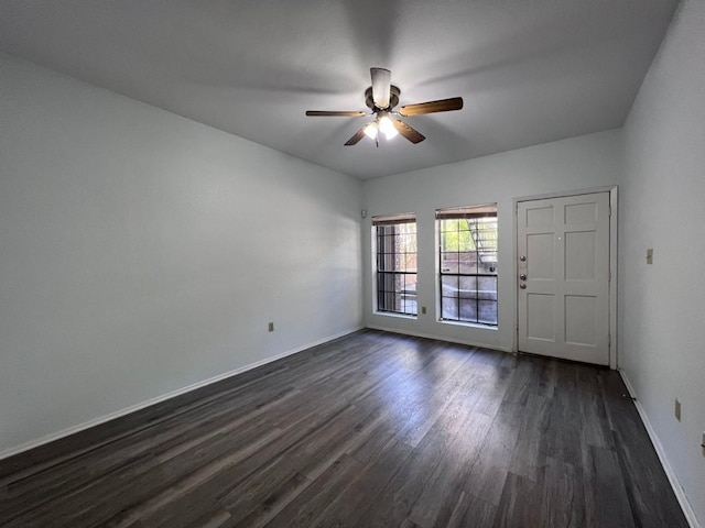 unfurnished room featuring dark hardwood / wood-style floors and ceiling fan