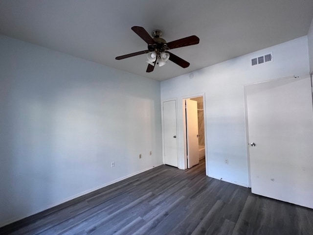 unfurnished bedroom with dark hardwood / wood-style flooring, ensuite bathroom, and ceiling fan