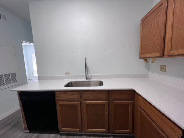 kitchen featuring kitchen peninsula, sink, dark hardwood / wood-style flooring, and black dishwasher