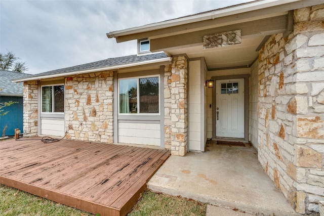 view of exterior entry with a deck