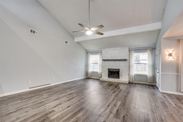 unfurnished living room with a fireplace, hardwood / wood-style flooring, a wealth of natural light, and ceiling fan