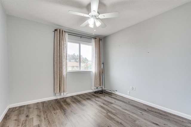 empty room featuring ceiling fan, light hardwood / wood-style floors, and a textured ceiling