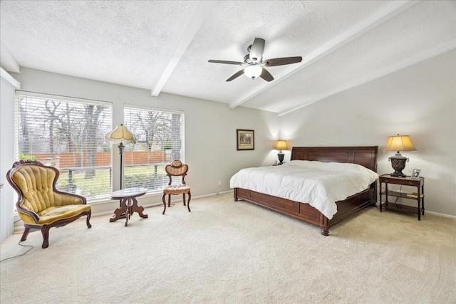 bedroom featuring vaulted ceiling with beams, ceiling fan, light colored carpet, and a textured ceiling