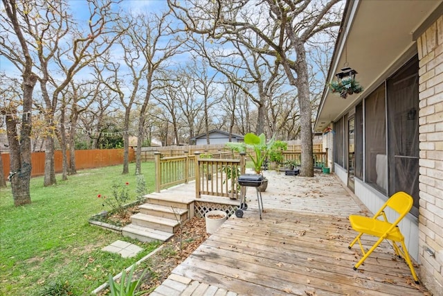 deck with a lawn and a sunroom