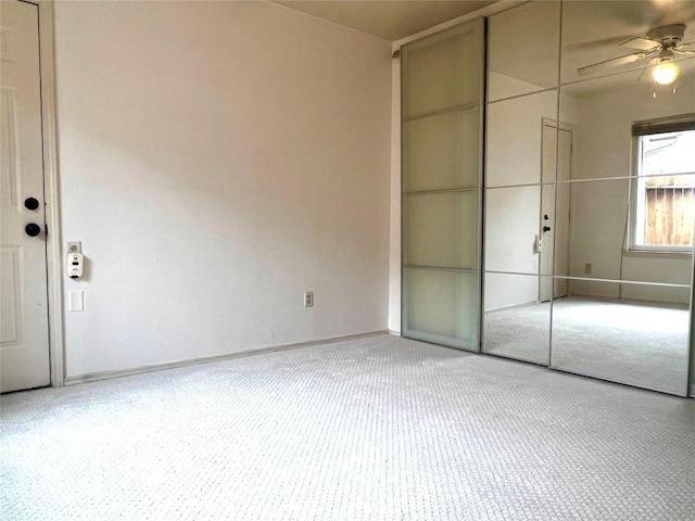 unfurnished bedroom featuring a closet, ceiling fan, and baseboards