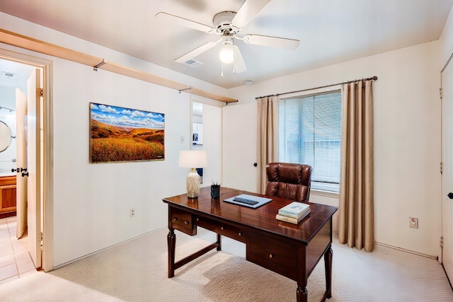 office with a ceiling fan and light colored carpet