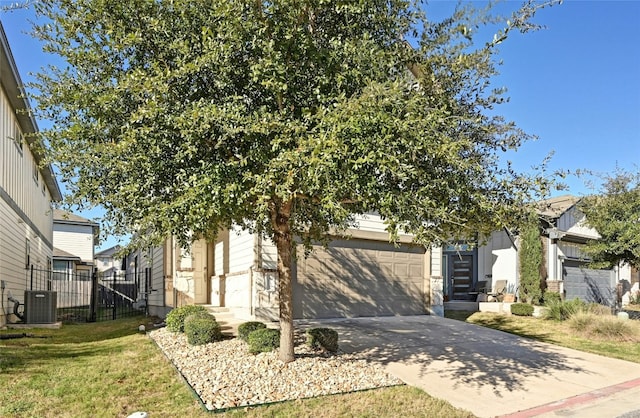 obstructed view of property featuring concrete driveway, fence, a front lawn, and central AC unit