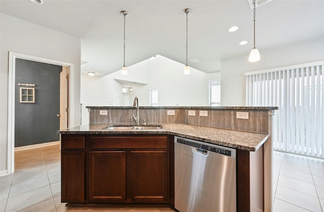 kitchen featuring a sink, an island with sink, stainless steel dishwasher, and light tile patterned floors