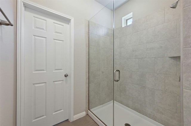 bathroom featuring a stall shower and tile patterned floors