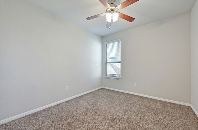 spare room with ceiling fan, baseboards, and light colored carpet