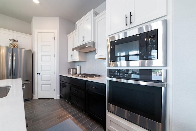 kitchen featuring white cabinets, backsplash, and stainless steel appliances