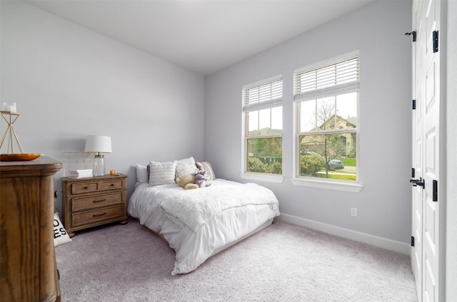 bedroom featuring light colored carpet