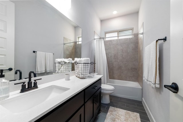 full bathroom with vanity, shower / bath combo, and toilet