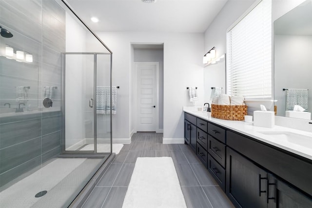 bathroom with a shower with door and vanity