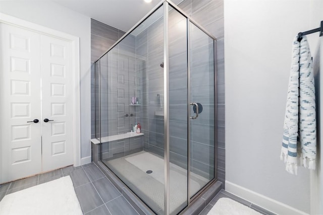 bathroom featuring tile patterned flooring and a shower with shower door