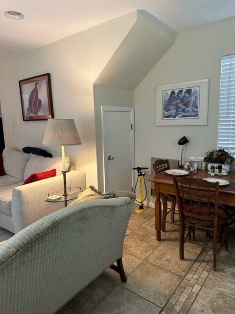 living room featuring lofted ceiling