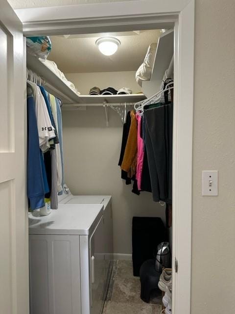 clothes washing area featuring washer and dryer