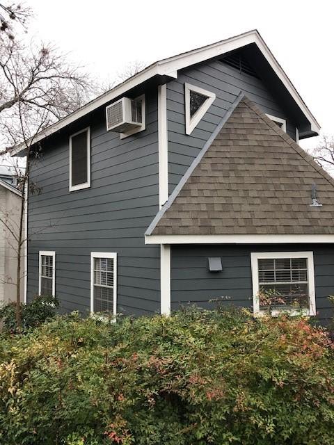 view of side of property featuring a wall unit AC