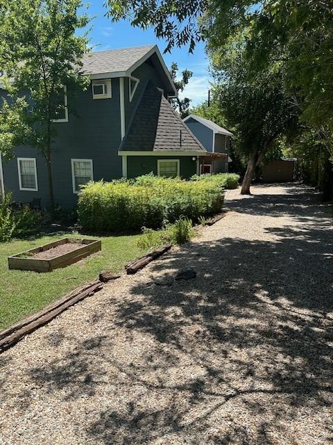 view of side of home featuring a lawn