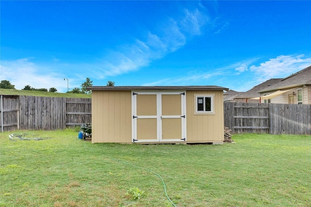 view of outdoor structure featuring a lawn