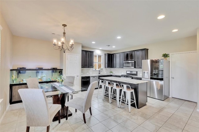 tiled dining space featuring an inviting chandelier and sink