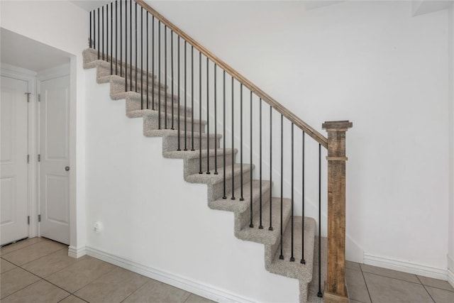 stairs featuring tile patterned floors