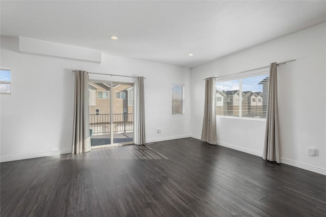 unfurnished room with dark hardwood / wood-style flooring