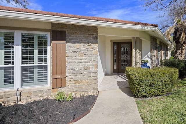 408 Silver Spur, Horseshoe Bay, TX 78657 - doorway to property with stone siding and stucco siding